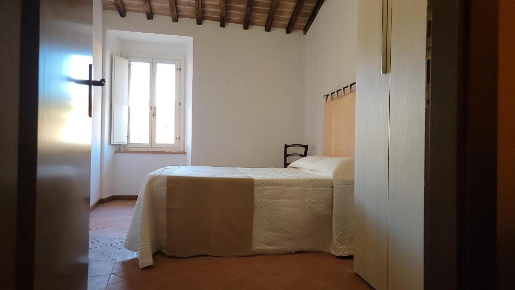Postel nebo postele na pokoji v ubytování Locanda Francescana