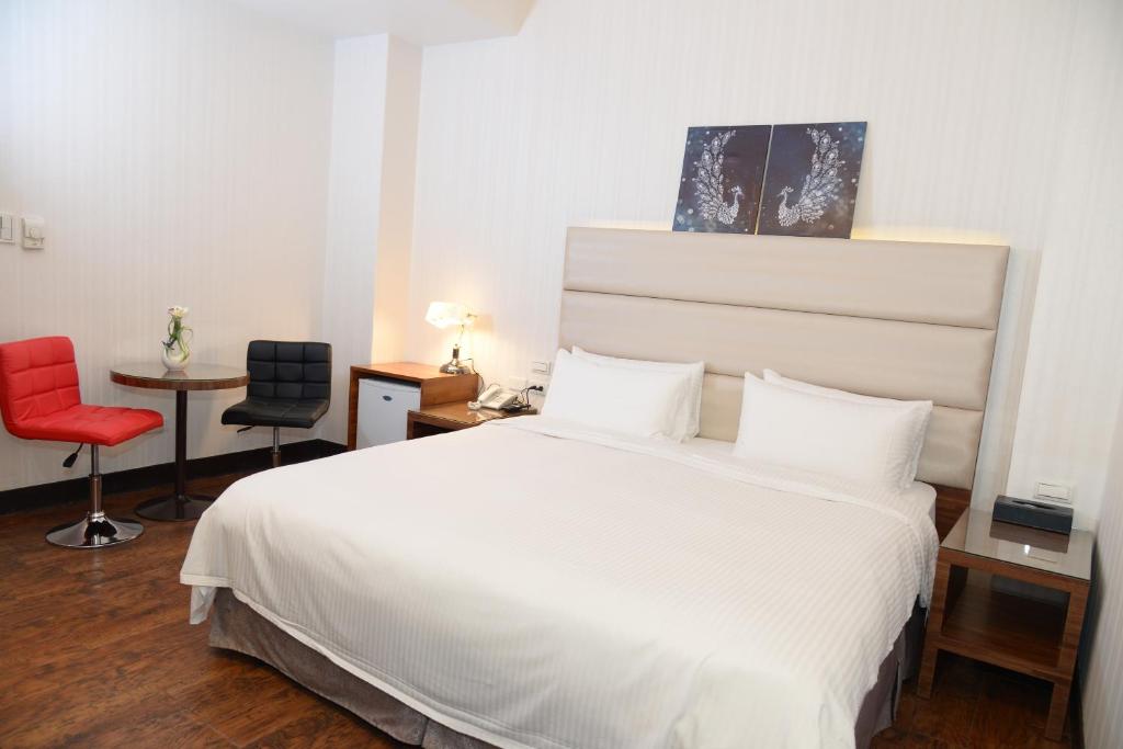 Postel nebo postele na pokoji v ubytování E-Coast Star Hotel