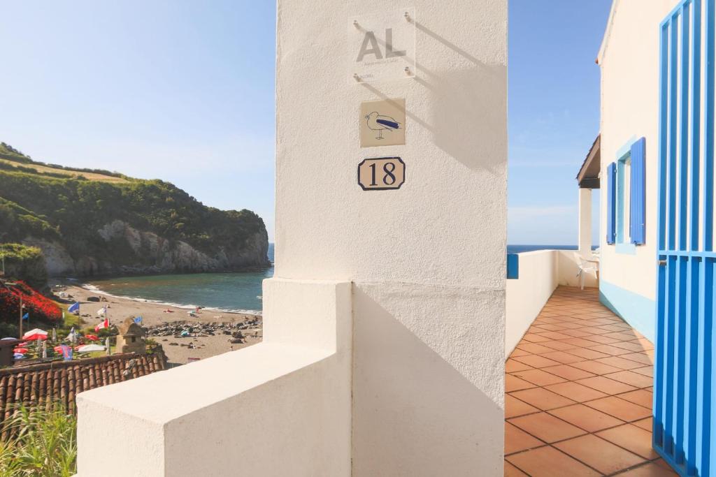 a building with a clock on the side of a beach at Beachfront Casa da Praia in Porto Formoso