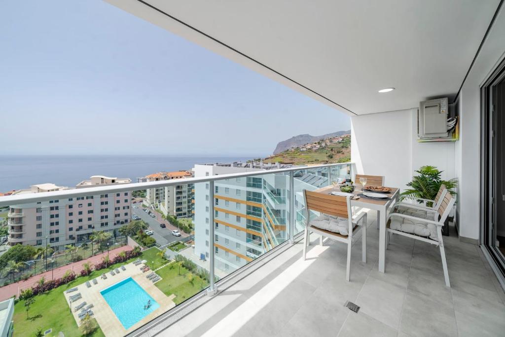 a balcony with a table and chairs and a view of the ocean at Alameda Formosa I by An Island Apart in Funchal