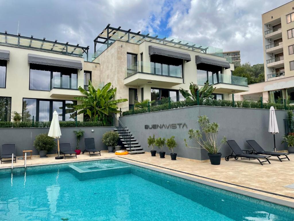 a swimming pool in front of a building at Buena Vista Villas in Varna City