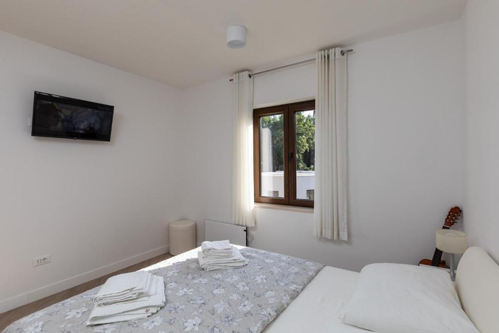Posteľ alebo postele v izbe v ubytovaní Apartments Setemana