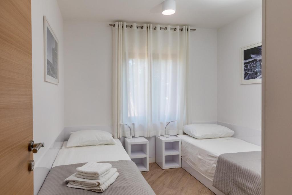 Posteľ alebo postele v izbe v ubytovaní Apartments Setemana