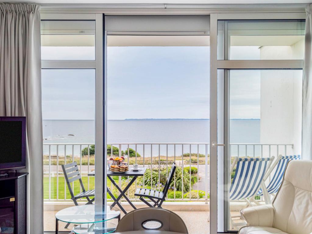 a living room with a view of the ocean at Apartment Les Trois Iles-9 by Interhome in Quiberon