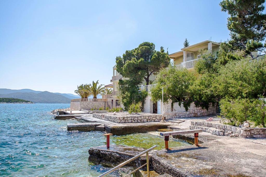 a house on the shore of a body of water at Apartments Krstičević in Klek