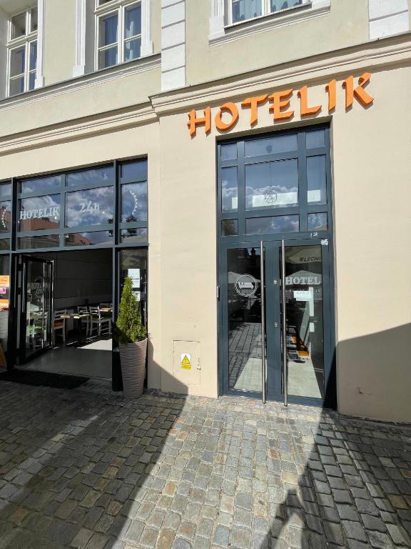 a building with a hotel sign on the front of it at Hotel City in Gniezno