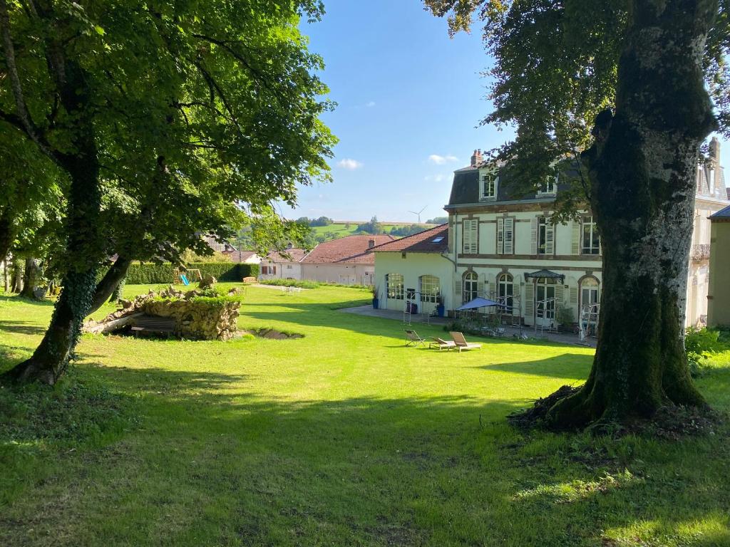 a large white house with trees in front of it at LE CHATEAU DE MONTHUREUX LE SEC in Monthureux-le-Sec