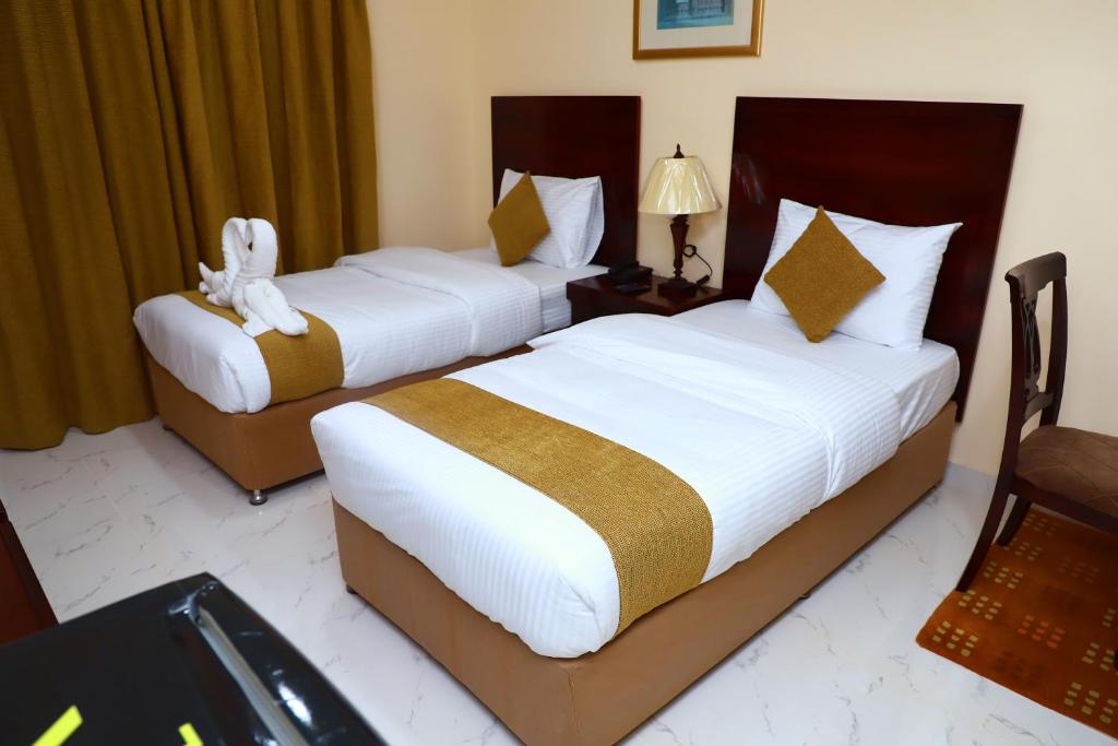 Postel nebo postele na pokoji v ubytování Onyx Hotel Apartments - MAHA HOSPITALITY GROUP