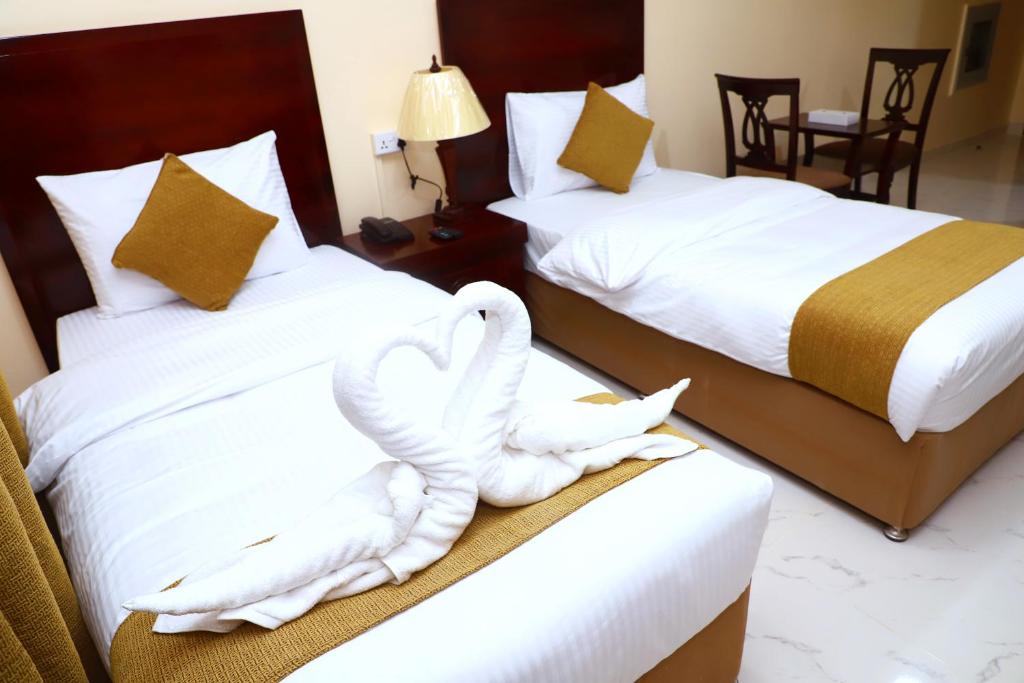 Postel nebo postele na pokoji v ubytování Onyx Hotel Apartments - MAHA HOSPITALITY GROUP