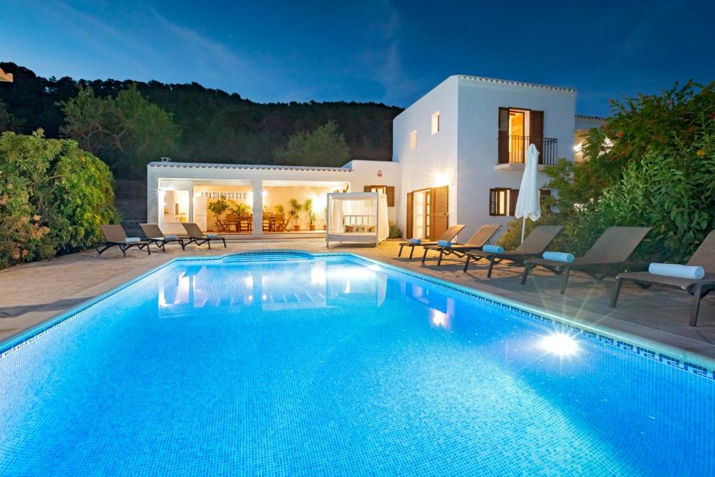 a swimming pool in front of a villa at Villa Near Ibiza Town - San Antonio Sleeps 14 in San Jose