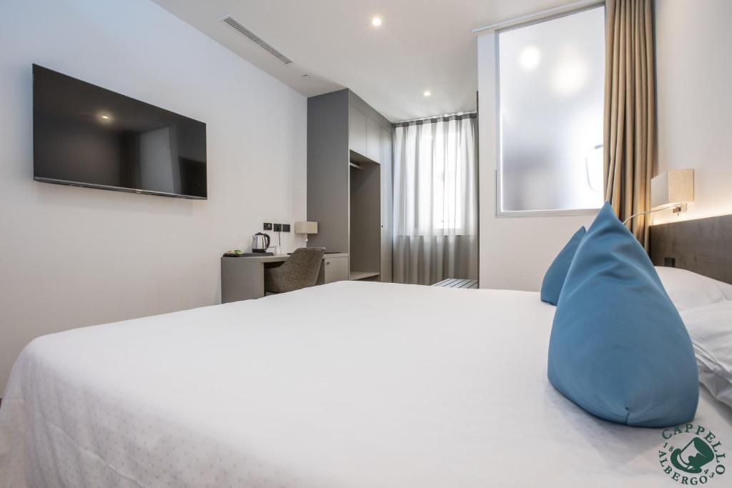 Voodi või voodid majutusasutuse Albergo Cappello e Cadore toas