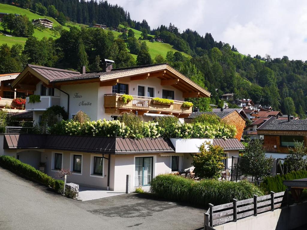 a house in a village with a mountain at Haus Monika in Brixen im Thale