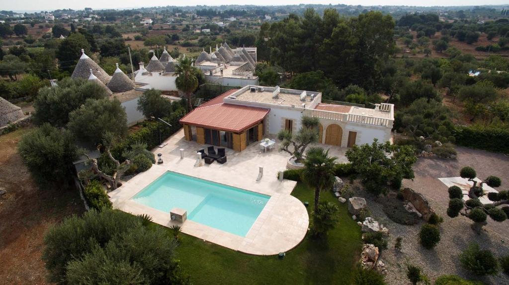 an aerial view of a house with a swimming pool at Villa Tesoro in Cisternino