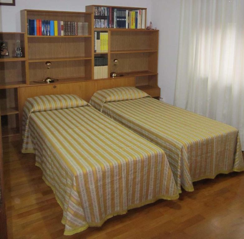 two beds sitting next to each other in a bedroom at B&B Ponte Marchese in Caldogno