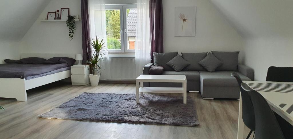 a living room with a couch and a table at Bonn/Königswinter ferienwohnung in Königswinter
