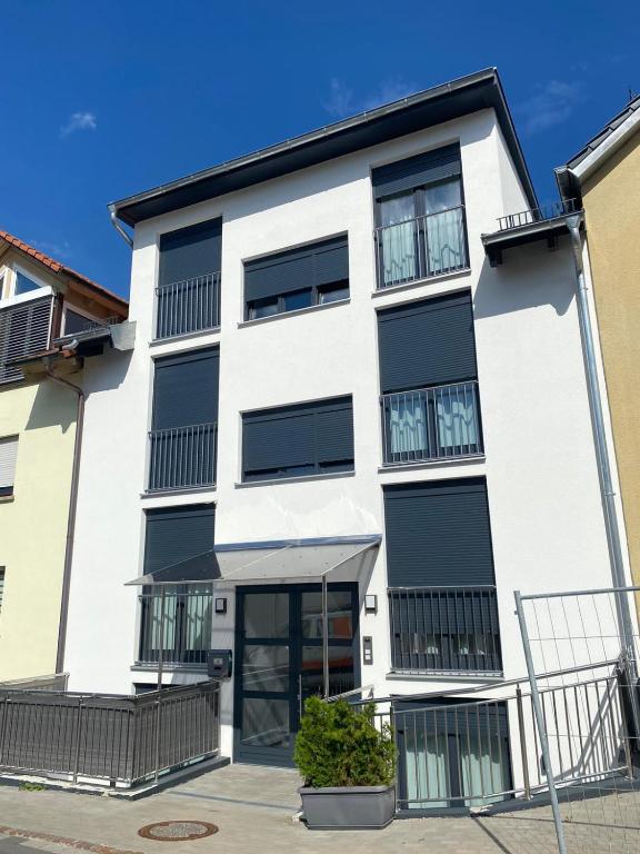 a white building with black shutters at Ferienwohnung Konstanz in Konstanz