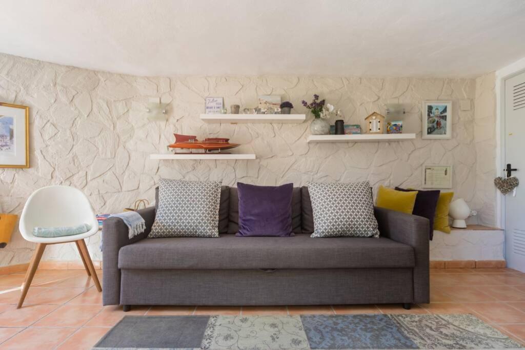 a living room with a gray couch with pillows at Boutique Apartment Altea La Vella in Altea