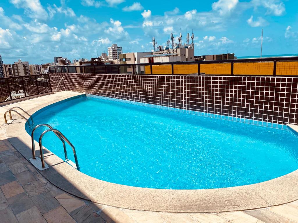 a swimming pool on the roof of a building at Quarto e sala com piscina próximo à praia in Maceió