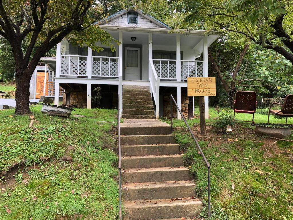 a white house with a sign in front of it at Cochran Farm House in Bryson City