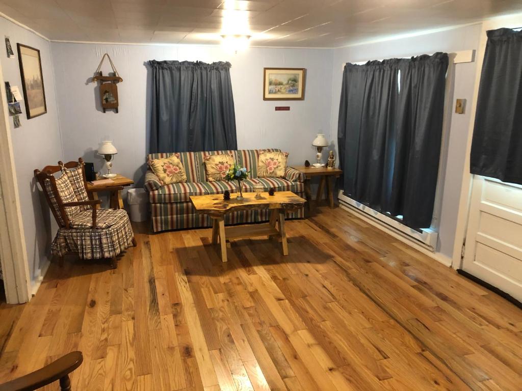 a living room with a couch and a table at Cochran Farm House in Bryson City