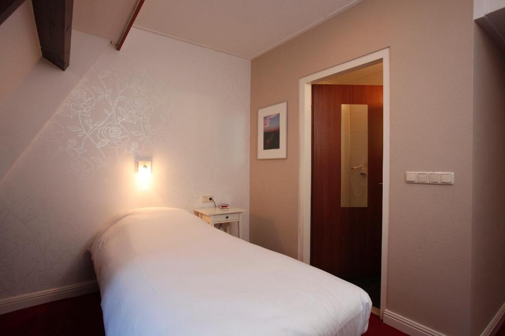 Postel nebo postele na pokoji v ubytování Hotel Restaurant Riche