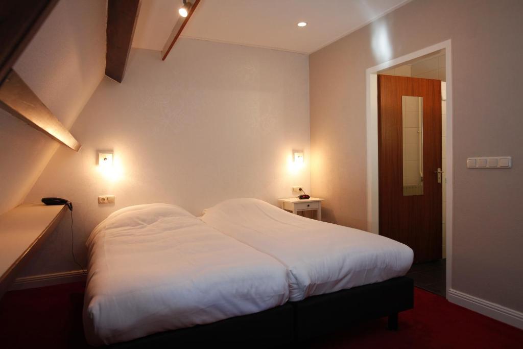 Postel nebo postele na pokoji v ubytování Hotel Restaurant Riche