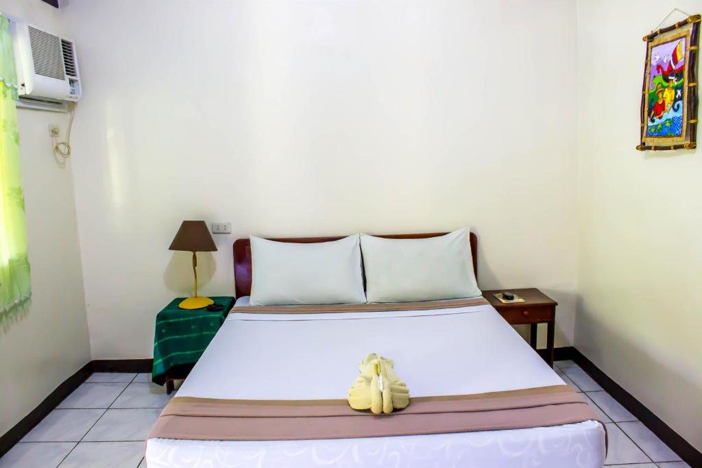 Postel nebo postele na pokoji v ubytování Remari Tourist Inn