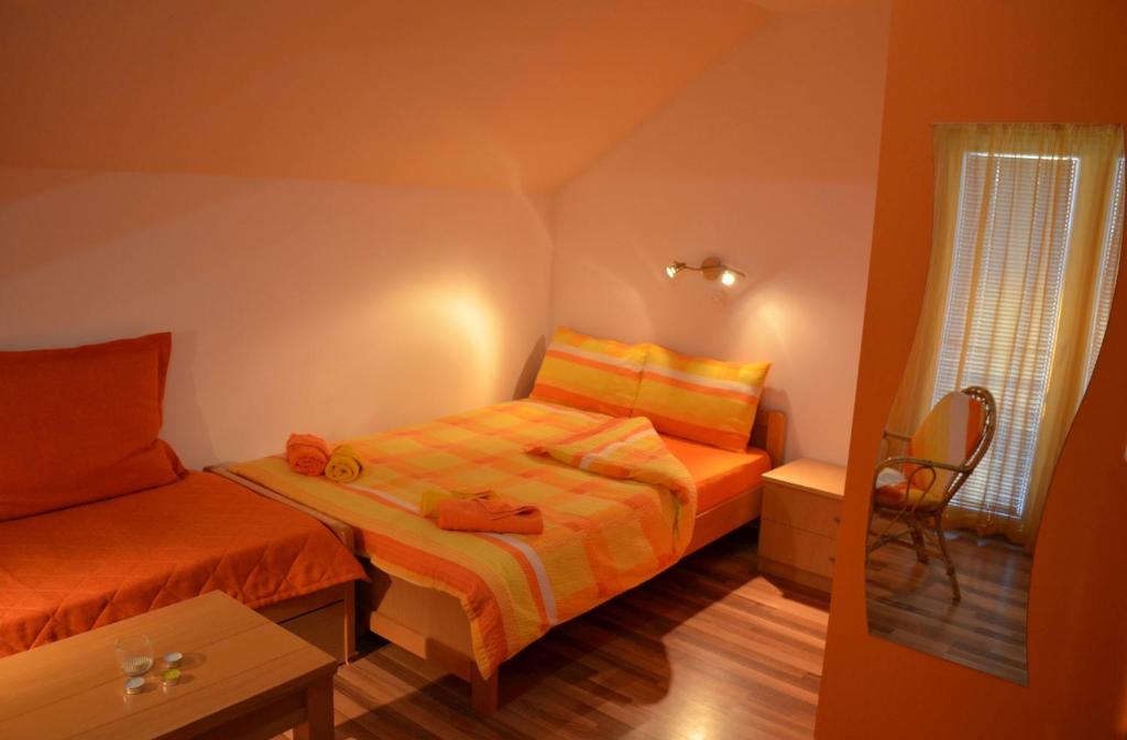 a small room with two beds and a window at Villa Vesna in Ohrid