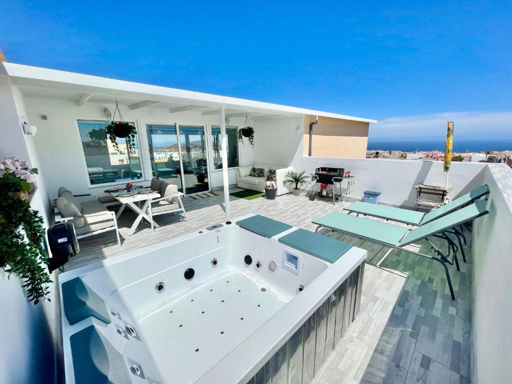 a house with a hot tub on a balcony at Villa Blanca Tenerife - Atico Loft in San Isidro