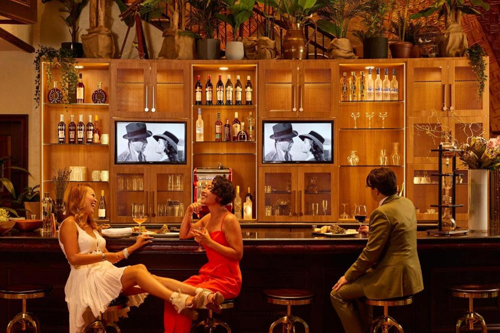 a group of people sitting at a bar at Hotel Le Soleil by Executive Hotels in Vancouver