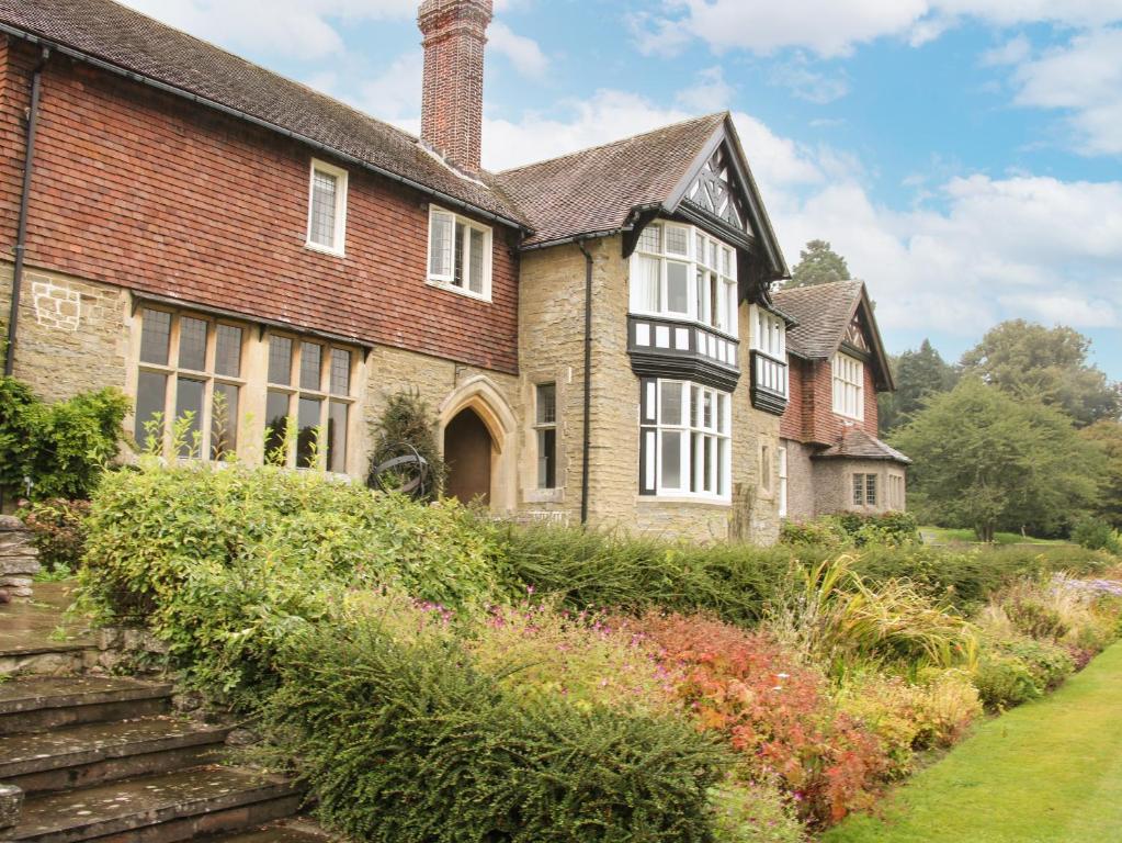 an old brick house with a garden in front of it at The Old Nursery in Much Wenlock