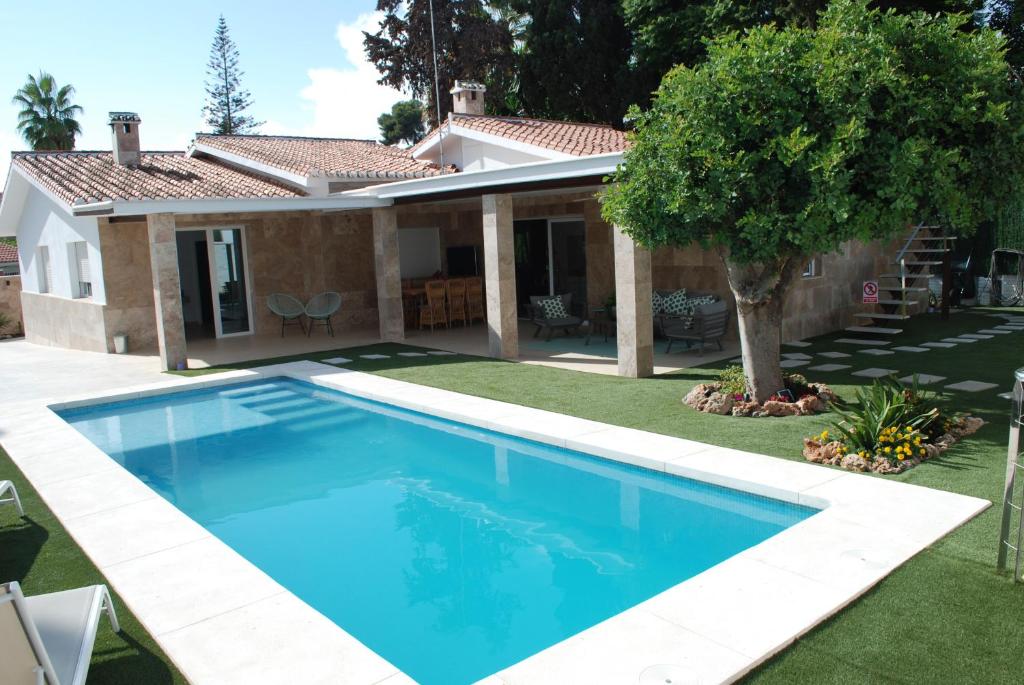 a swimming pool in front of a house at CASA VACACIONAL MÁLAGA 14 Chalet in Málaga