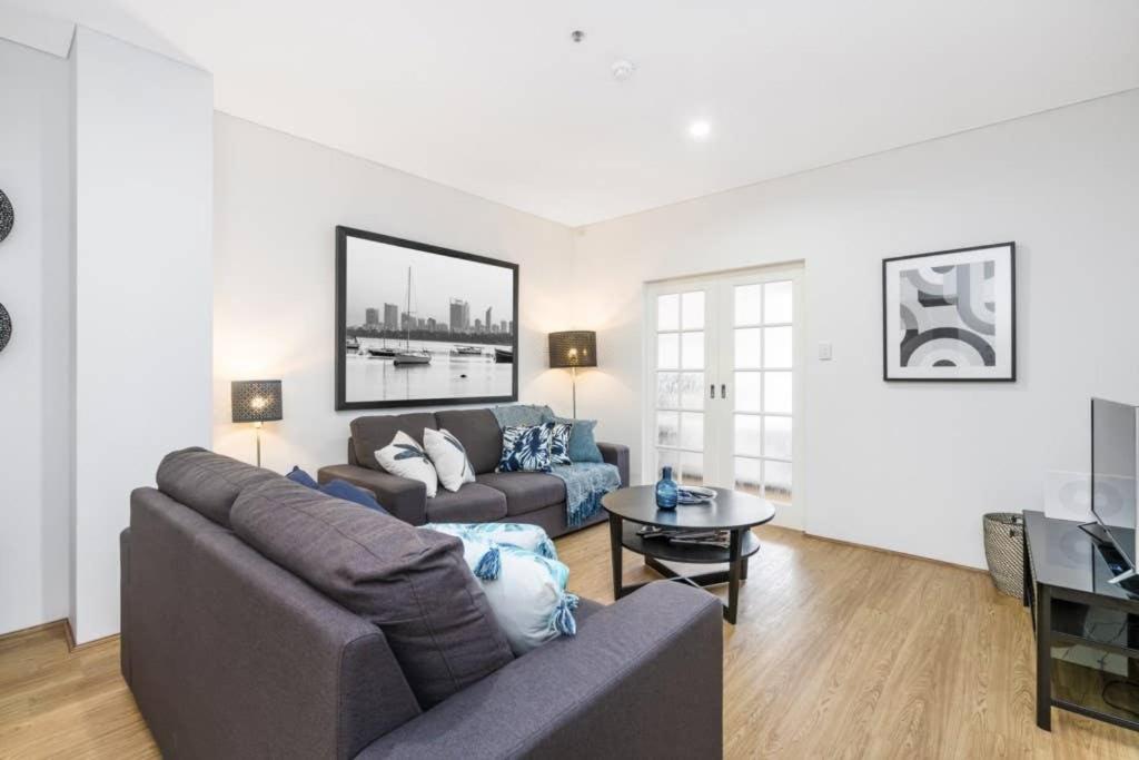 a living room with a couch and a table at 504 - Perth Cbd Huge 1br 1ba Beauty in Perth