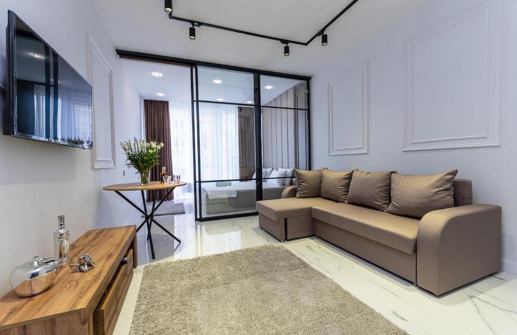 a living room with a couch and a table at Fashionable apartments. Smartplaza metro Minskaya. Obolon in Kyiv