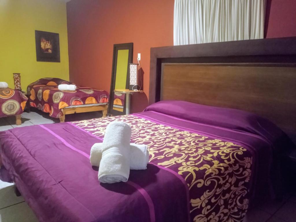 a bedroom with a bed with a stuffed animal on it at Casa Cantares in Guanajuato