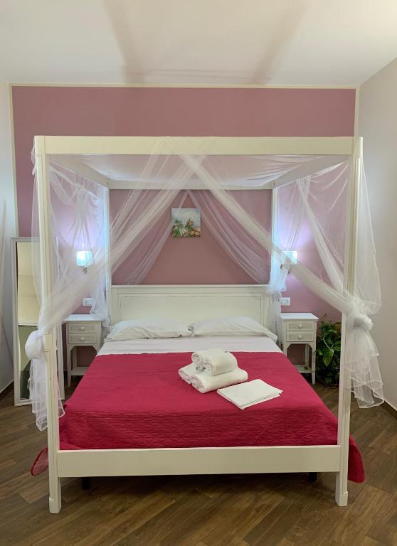 Łóżko lub łóżka w pokoju w obiekcie All’Anoneto B&B