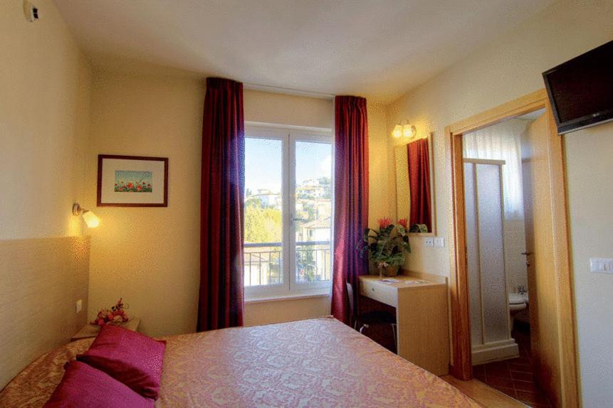 Łóżko lub łóżka w pokoju w obiekcie Hotel Granducato