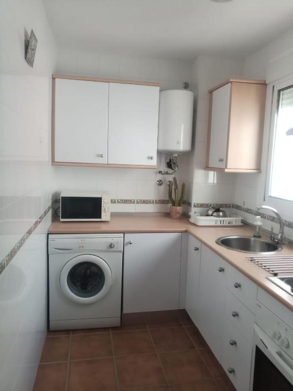 A kitchen or kitchenette at ALCARAVAN 50