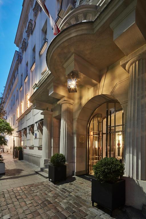 an entrance to a building with potted plants on a sidewalk at H15 Boutique Hotel, Warsaw, a Member of Design Hotels in Warsaw