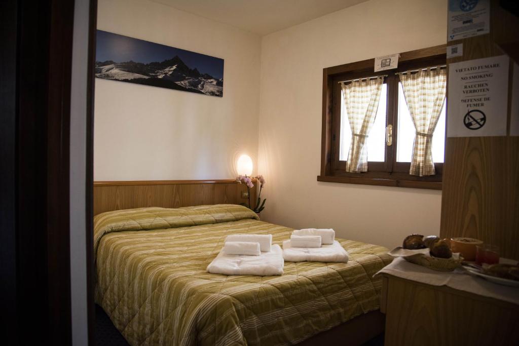 Postel nebo postele na pokoji v ubytování Hotel Marguareis