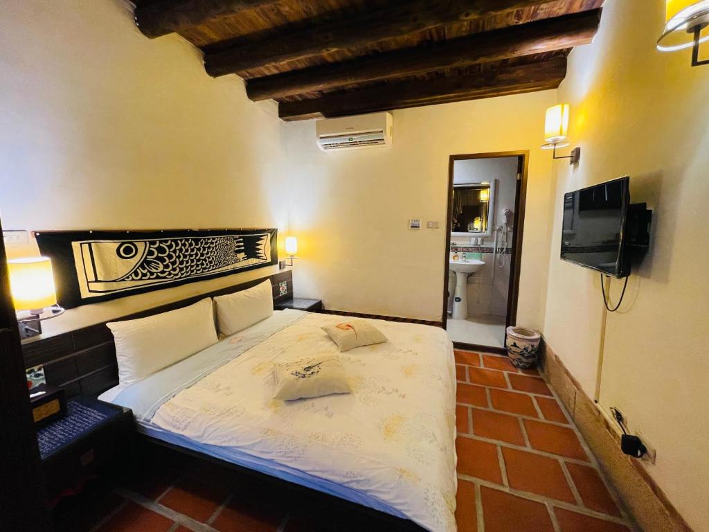 Postel nebo postele na pokoji v ubytování Grace Kinmen B&B