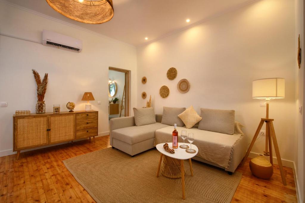 a living room with a couch and a table at LA MAISONETTE HOUSE IN THE HEART OF LIAPADES CLOSE TO ROVINIA BEACH & PALEOKASTRITSA New! PARKING AVAILABLE in Liapades