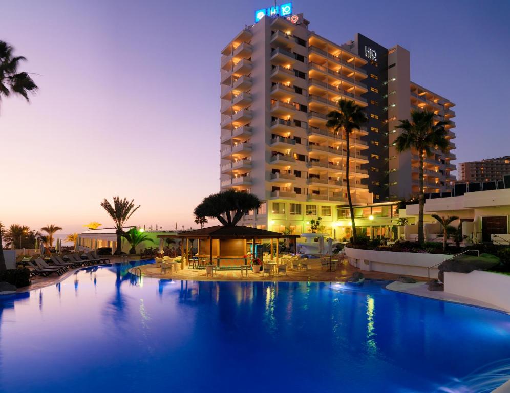 a hotel with a large pool in front of a building at H10 Gran Tinerfe - Adults Only in Adeje