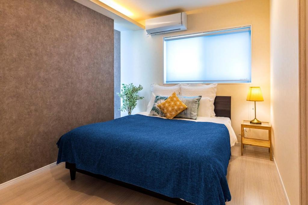 Postel nebo postele na pokoji v ubytování Condominium Luana 築浅2LDK 宮城海岸徒歩2分 American Village 車で10分