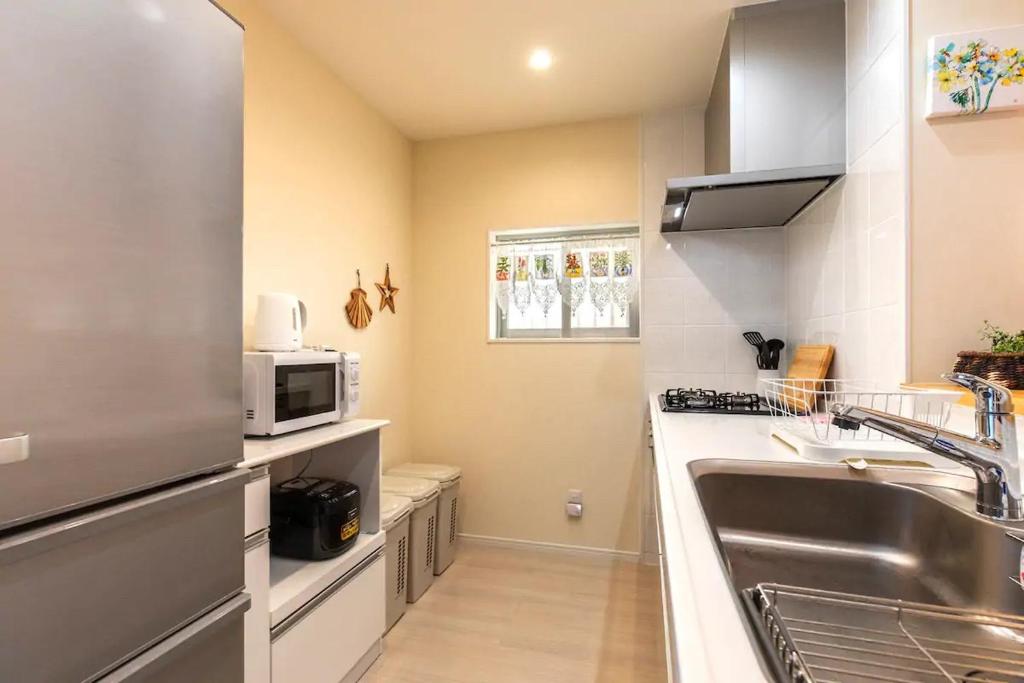 Kuchyň nebo kuchyňský kout v ubytování Condominium Luana 築浅2LDK 宮城海岸徒歩2分 American Village 車で10分
