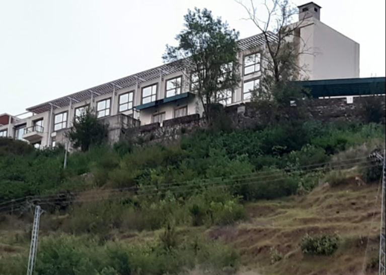 a building on the side of a hill at Hotel Orash Lodge in Nāluchhi