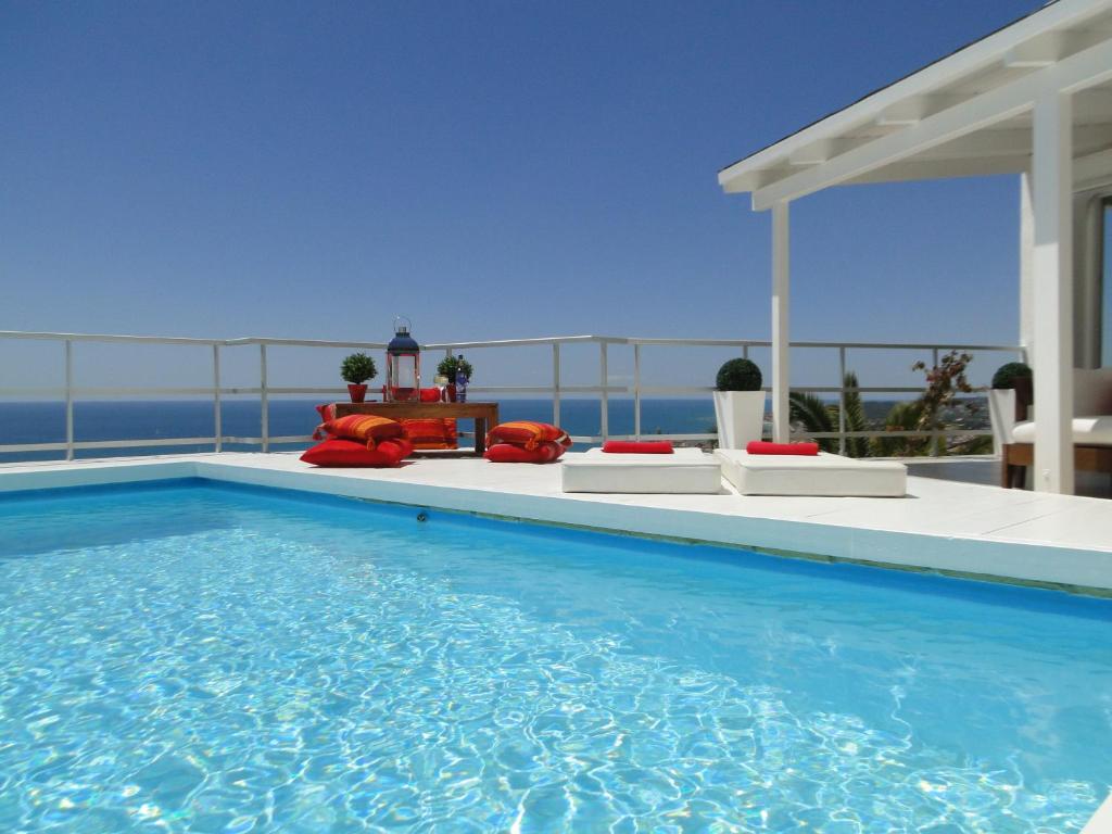 a swimming pool with a view of the ocean at Villa Sitges Altavista Amazing View South oriented Calm Area AC Beach 2 minutes in Sitges