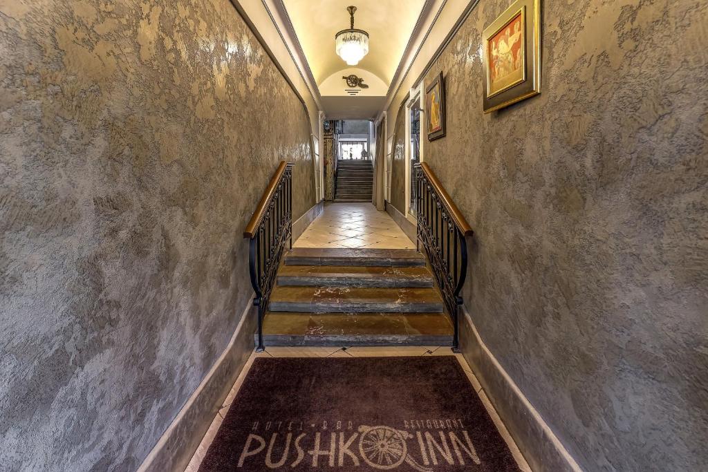a hallway with stairs in an old building at Pushka INN hotel in Saint Petersburg