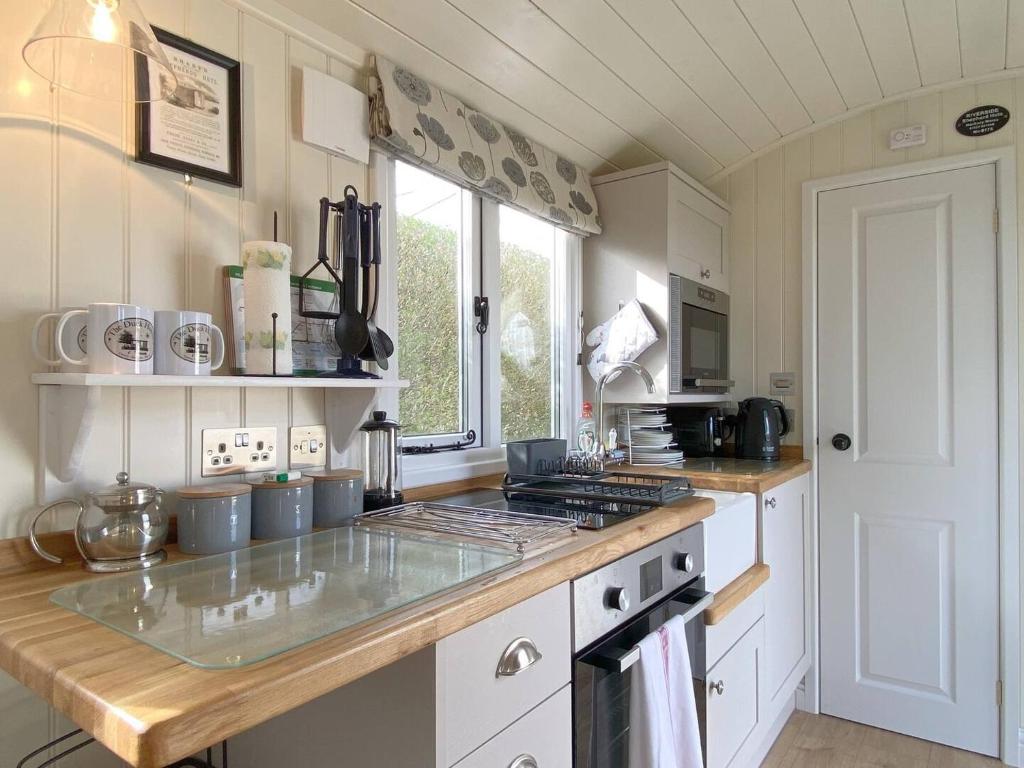 a kitchen with a counter and a stove top oven at The Duck House in Swansea