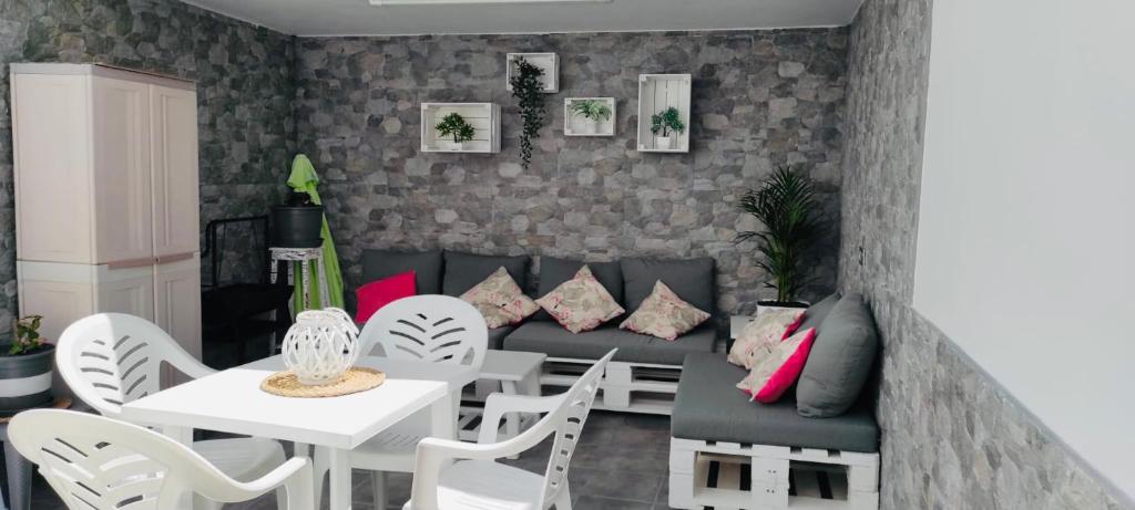 a living room with a couch and a table and chairs at Apartamento Yale in Tías